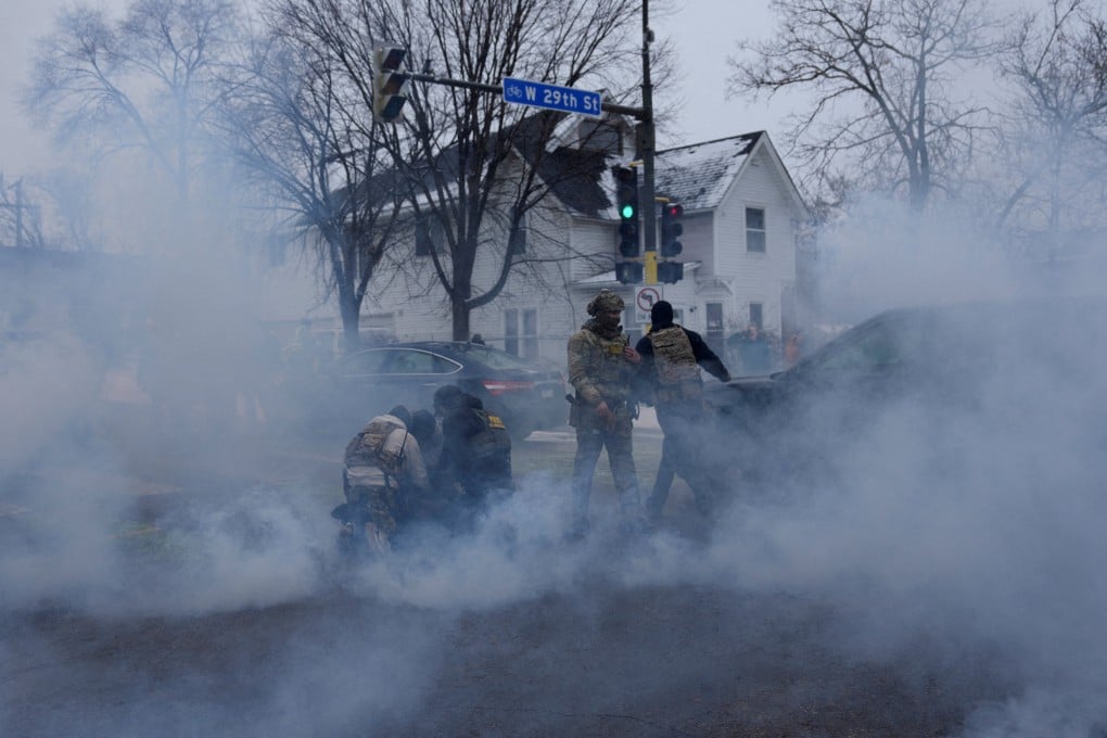 US federal agents detain a person while surrounded by tear gas used to deter protesters following a fatal ICE shooting, in Minneapolis on January 21. Photo: Reuters
