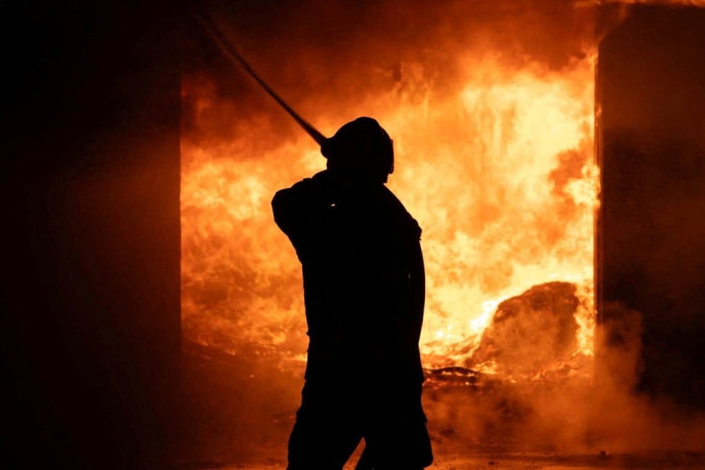 A firefighter works at a site of a Russian strike on Sunday. Photo: Ukraine State Emergency Service/Reuters