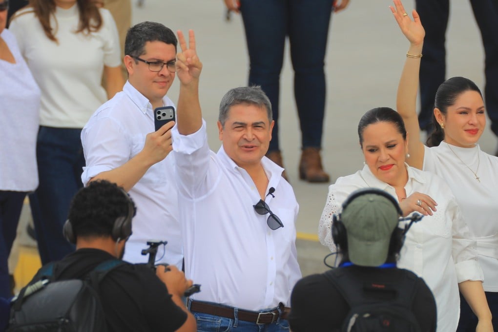 Former Honduras’ President Juan Orlando Hernandez, centre, with his wife Ana Garcia, right, and daughter Daniela Hernandez, far right, at Palmerola Airport near Honduras’ capital Tegucigalpa on Sunday. Photo: EPA
