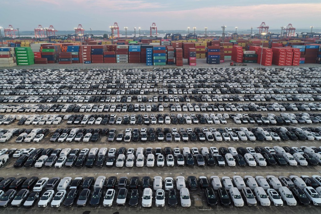 Chinese-made Volvo cars are seen alongside containers before being loaded onto ships for export at the port in Nanjing, China’s eastern Jiangsu province. Photo: AFP