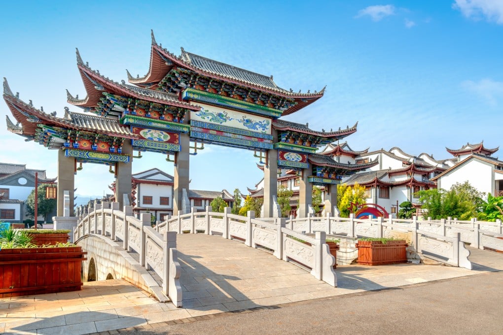 China’s young people are increasingly quitting stressful corporate jobs and choosing simpler, cheaper lives in scenic rural towns. Pictured is the entrance archway to Mengzi Rice Noodle Town in Yunnan province. Photo: Getty Images