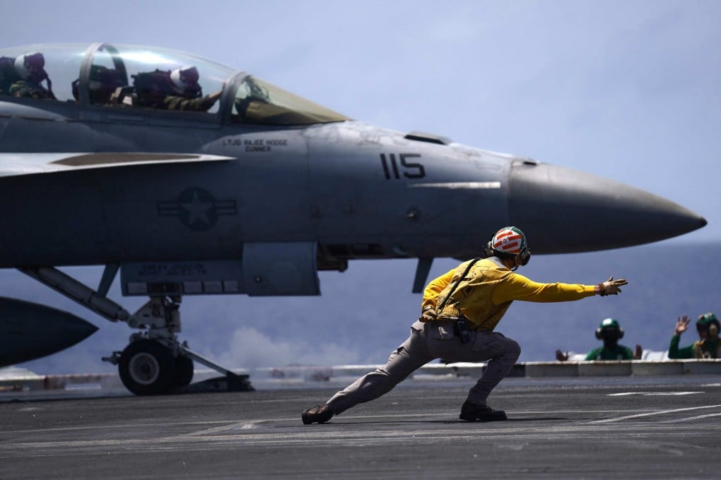 A US Navy F/A-18F Super Hornet gets into position on the flight deck of the USS Theodore Roosevelt during the Rimpac exercise on July 17. Photo: AFP