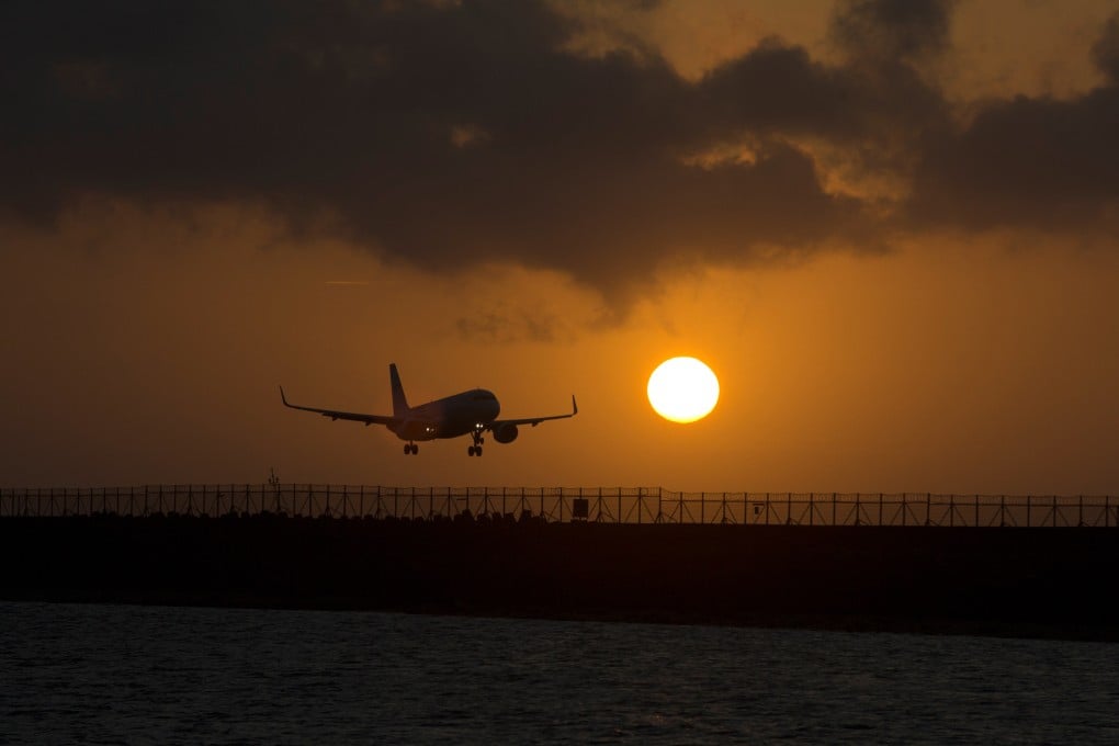 A passenger jet lands at I Gusti Ngurah Rai International Airport during sunset in Badung, Bali, Indonesia. Photo: AP