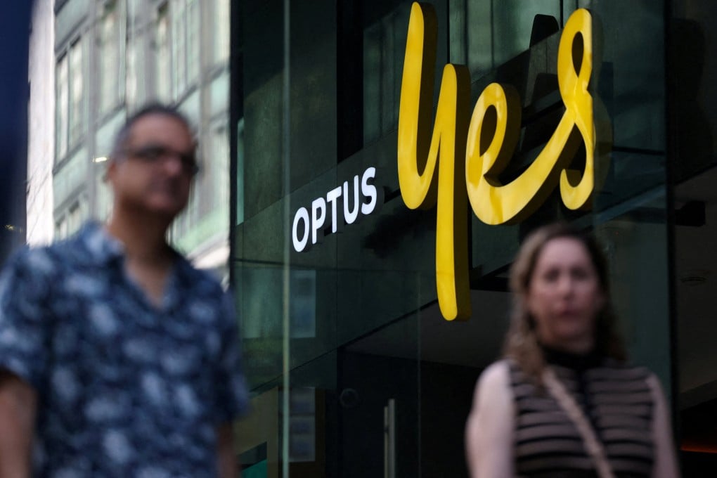 People walk past an Optus store in Sydney on September 29, 2025. Photo: Reuters