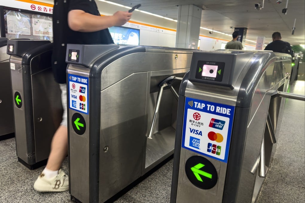A man passes through a turnstile at a metro station in Shanghai. The city is considering raising fares for the first time in more than two decades. Photo: VCG via Getty Images