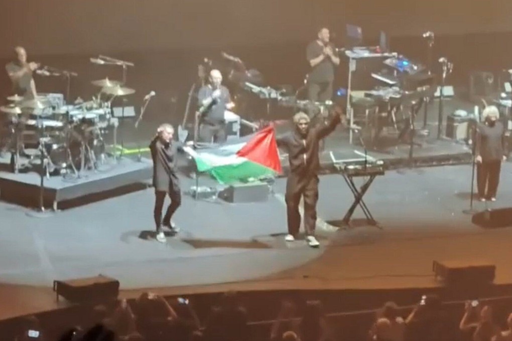 Massive Attack holds up a Palestinian flag during its concert in Singapore on Wednesday. Photo: Reddit/blushie157