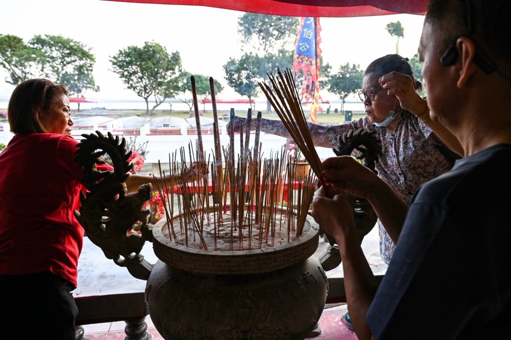 Devotees burn incense at a Taoist temple with Buddhist elements on Singapore’s Kusu island in 2023. Photo: AFP