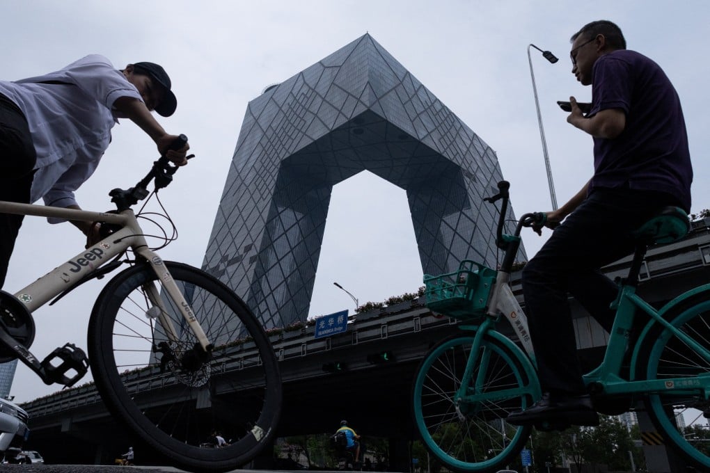 People ride bicycles in the central business district of Beijing. Photo: Reuters