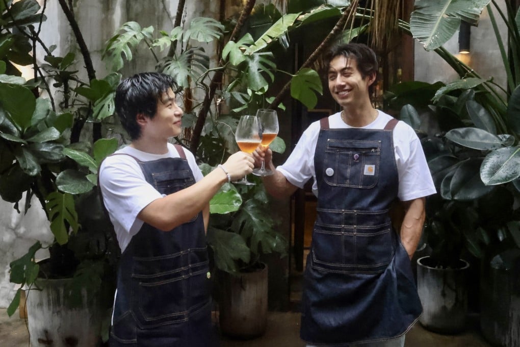 Purple Rain Wine founders Anson Sik (left) and Edson Bichon make a toast. The Gen Z entrepreneurs founded their company to bring Chinese natural wines to drinkers in Hong Kong, and to tell the stories behind the bottles. Photo: Jonathan Wong