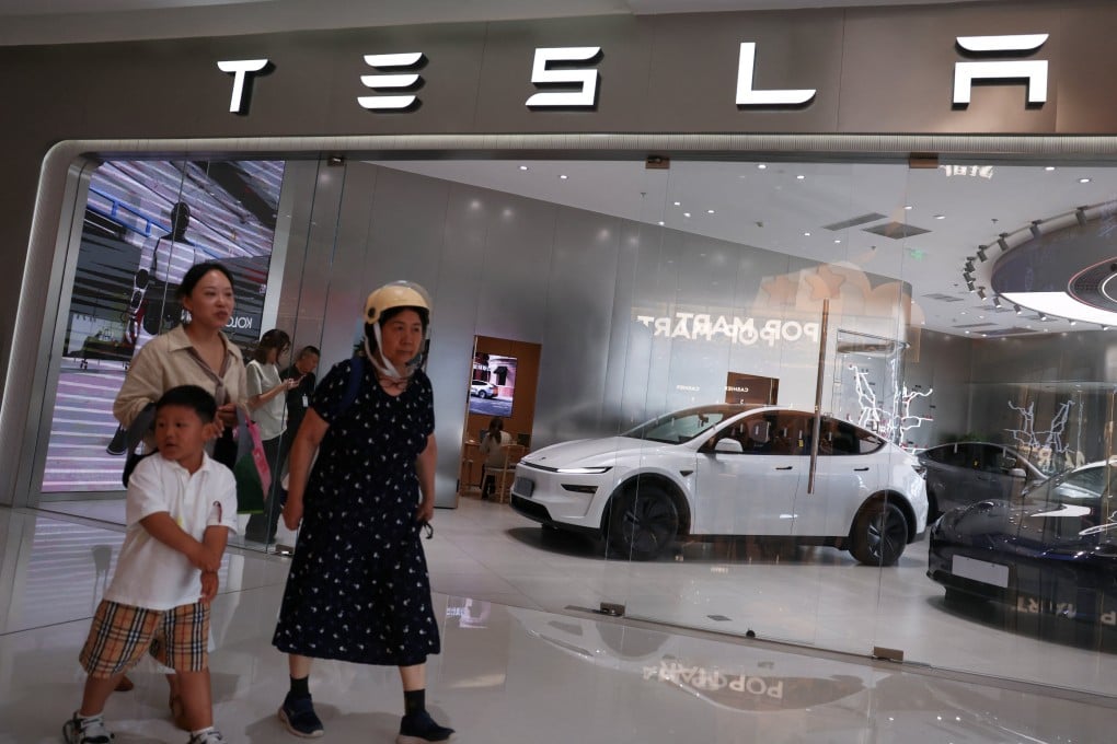 People walk past a Tesla store at a shopping mall in Beijing on July 31. Photo: Reuters