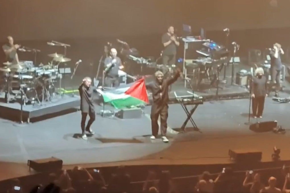 Two members of Massive Attack hold up a Palestinian flag during its concert in Singapore on Wednesday. Photo: Reddit/blushie157