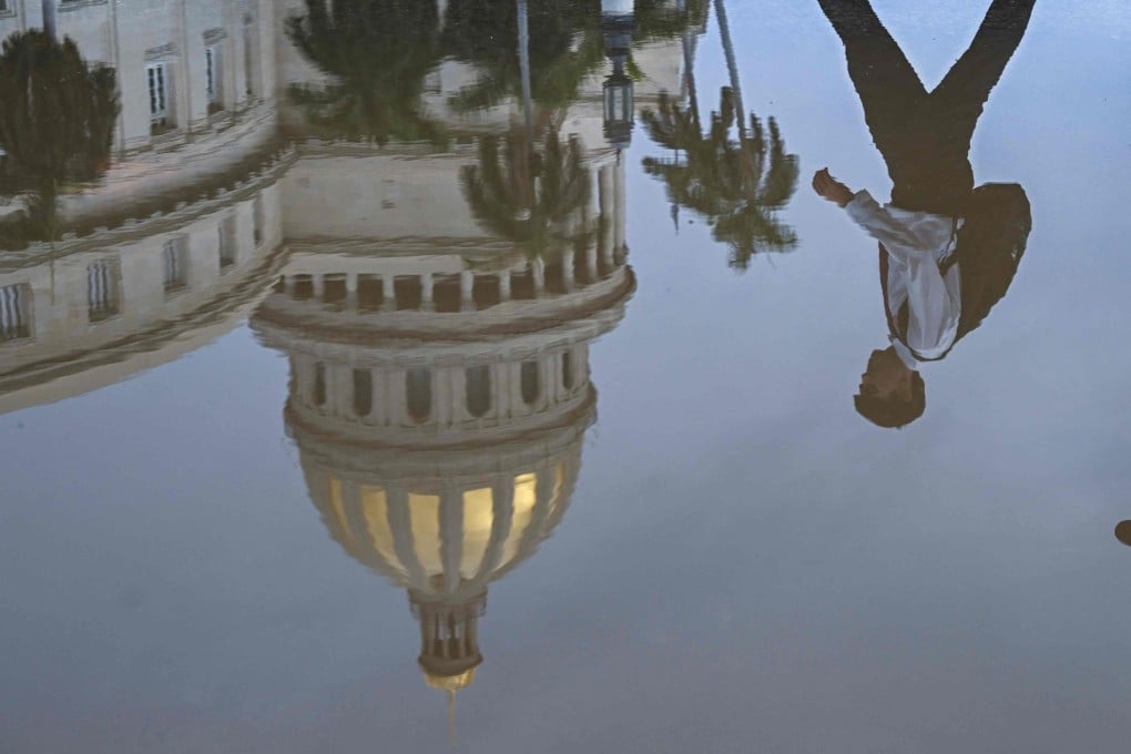 The Havana Capitol is seen reflected in a puddle on July 11. Photo: AFP