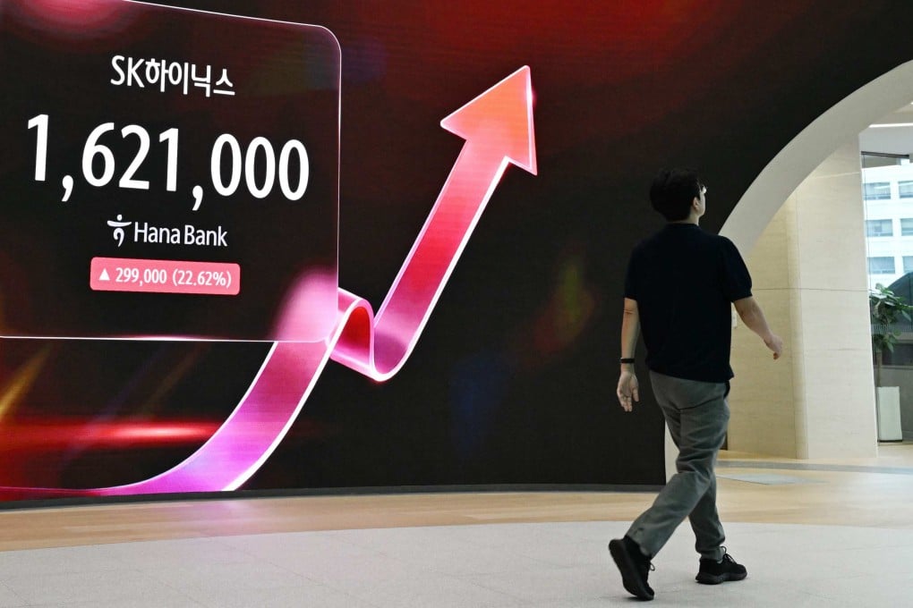 A man walks past an electronic screen showing the SK Hynix stock price outside a foreign exchange dealing room at the Hana Bank headquarters in Seoul on July 31. Photo: AFP