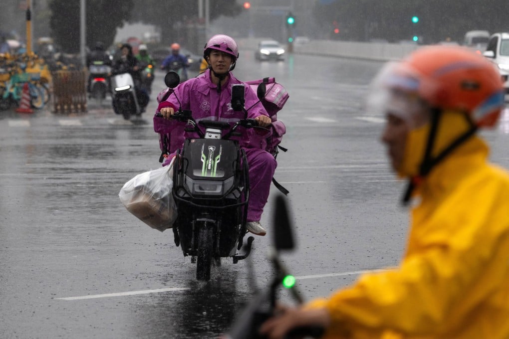 Delivery couriers ride bikes in Beijing on July 10. Photo: Reuters