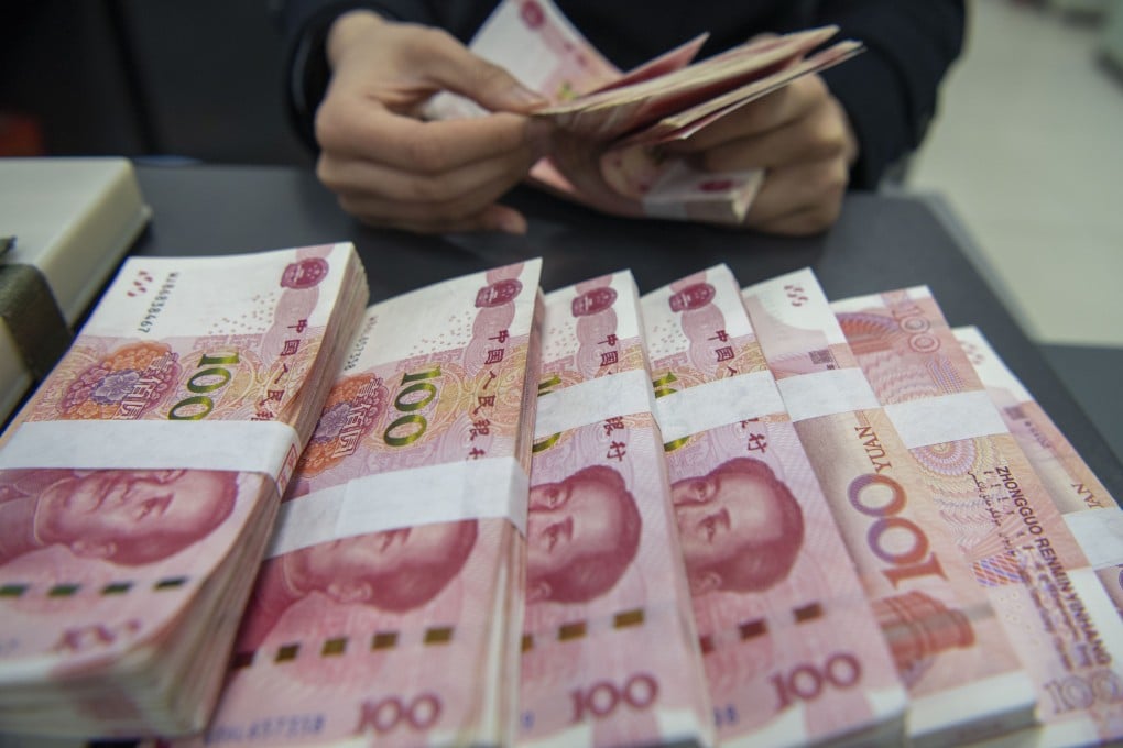 A staff member of a bank in Haian, Jiangsu province, counts 100 yuan notes in March 2024. Foreign institutions held around 2 trillion yuan of Chinese government bonds as of the end of June 2026. Photo: Getty Images
