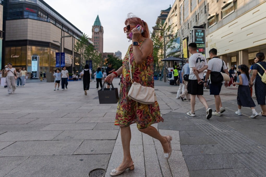 A woman walks through Wangfujing Street in Beijing on July 8. China’s population aged 60 and above reached 323 million by the end of 2025. Photo: Reuters