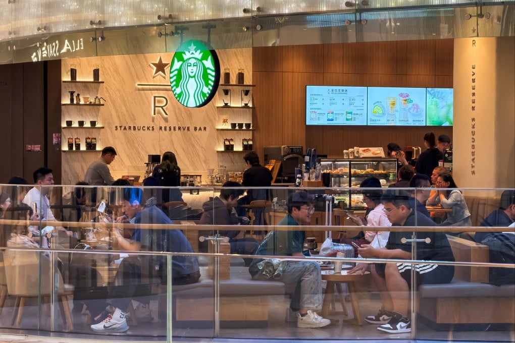 Customers sit and drink coffee inside a Starbucks Reserve store in a shopping mall in Shenzhen. Photo: Getty Images