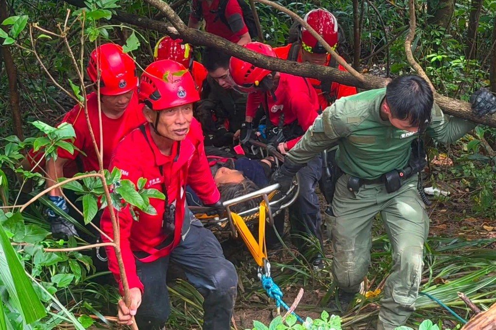 Rescuers prepare to airlift the woman after finding her on a hillside. Photo: Handout