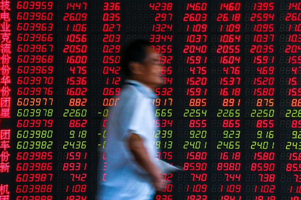 An investor walks by an electronic board displaying stock prices at a brokerage house in Beijing. China's stock traders unwound their leveraged positions in July, fuelling a brutal technology stock sell-off. Photo: AP