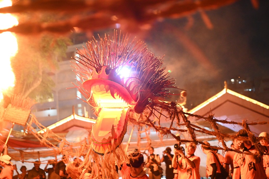 Spectators watch the Fire Dragon Dance of Sar Kong Mun San Fook Tuck Chee in March 2026. Every three years, the dragon is offered back to the deities through fire, reducing its physical form to ashes. This act is not an end but a renewal. Photo: Yeo GT