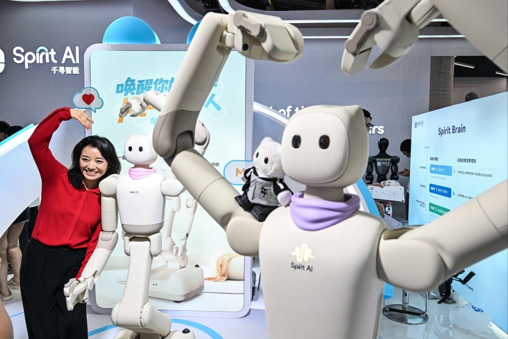 A woman poses next to humanoid robots by Spirit AI during the World Artificial Intelligence Conference in Shanghai on July 18. Photo: AFP
