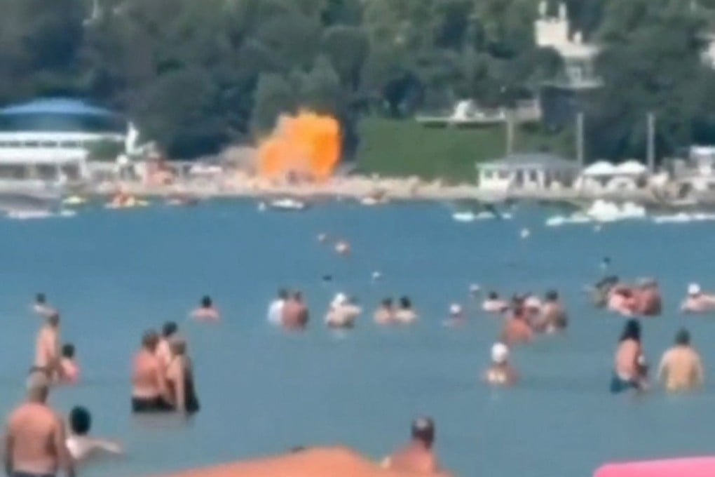 An image from social media footage shows an explosion on a busy beach at the holiday village of Arkhipo-Osipovka, as tourists look on. Photo: Social media via Reuters