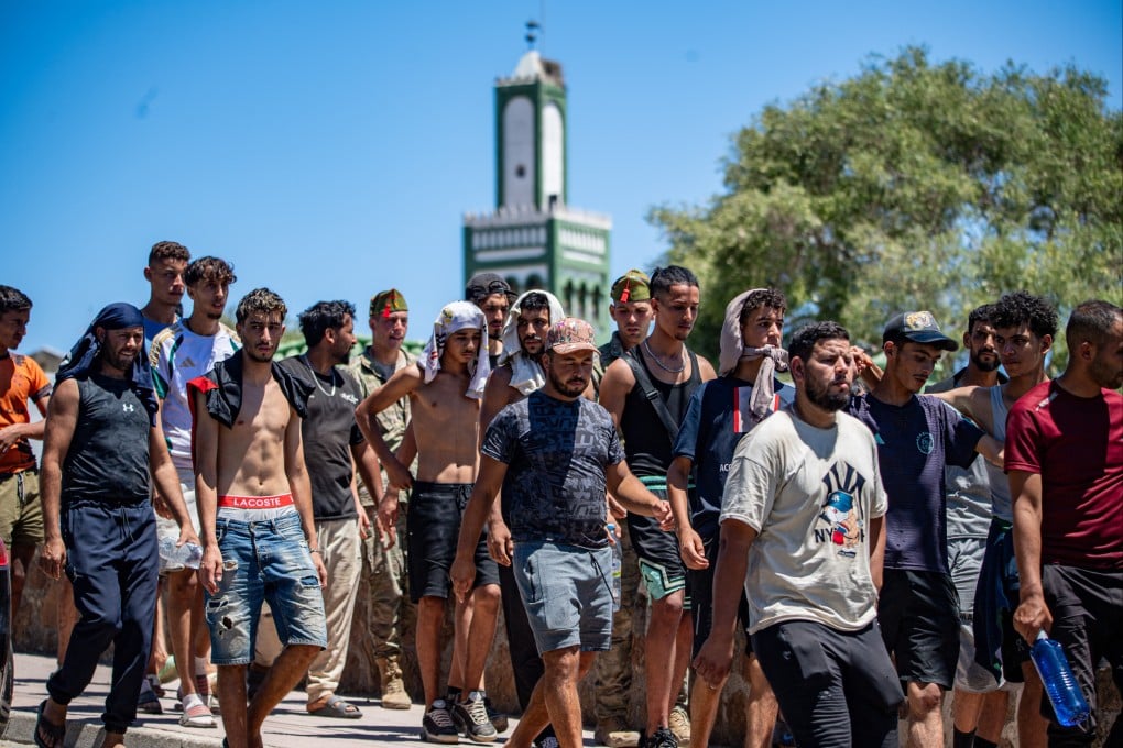 Migrants are escorted by Spanish soldiers towards the Spanish-Moroccan border for their return to Morocco from the Spanish territory of Ceuta on Sunday. Photo: AP