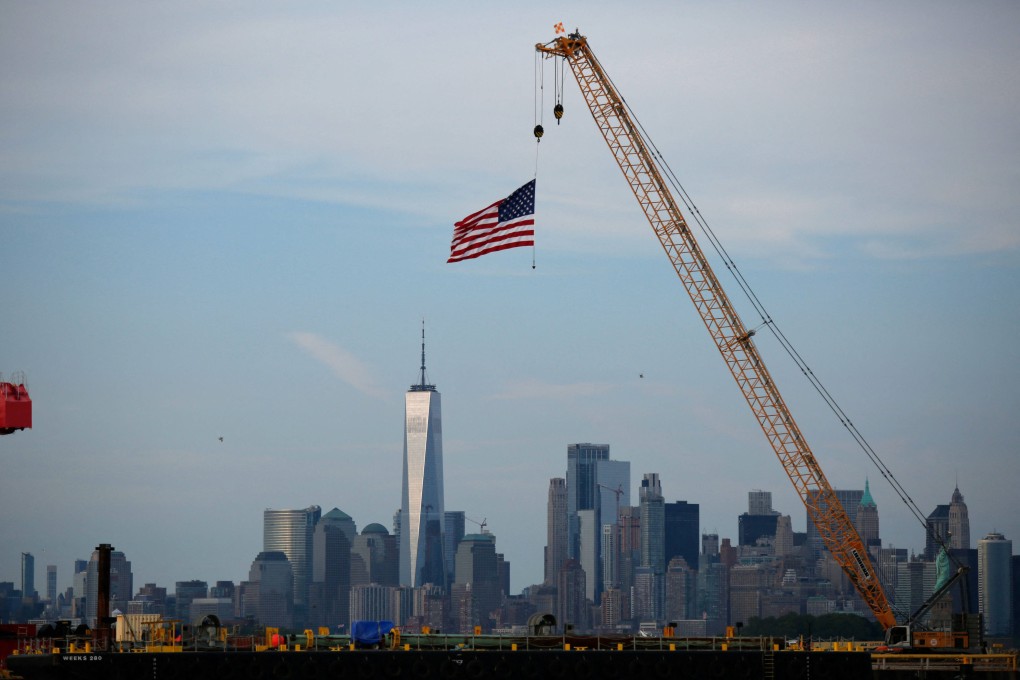 An American flag hangs from a crane at Port Liberty in Bayonne, New Jersey. US President Donald Trump slapped sweeping new tariffs on dozens of trading partners. Photo: AFP