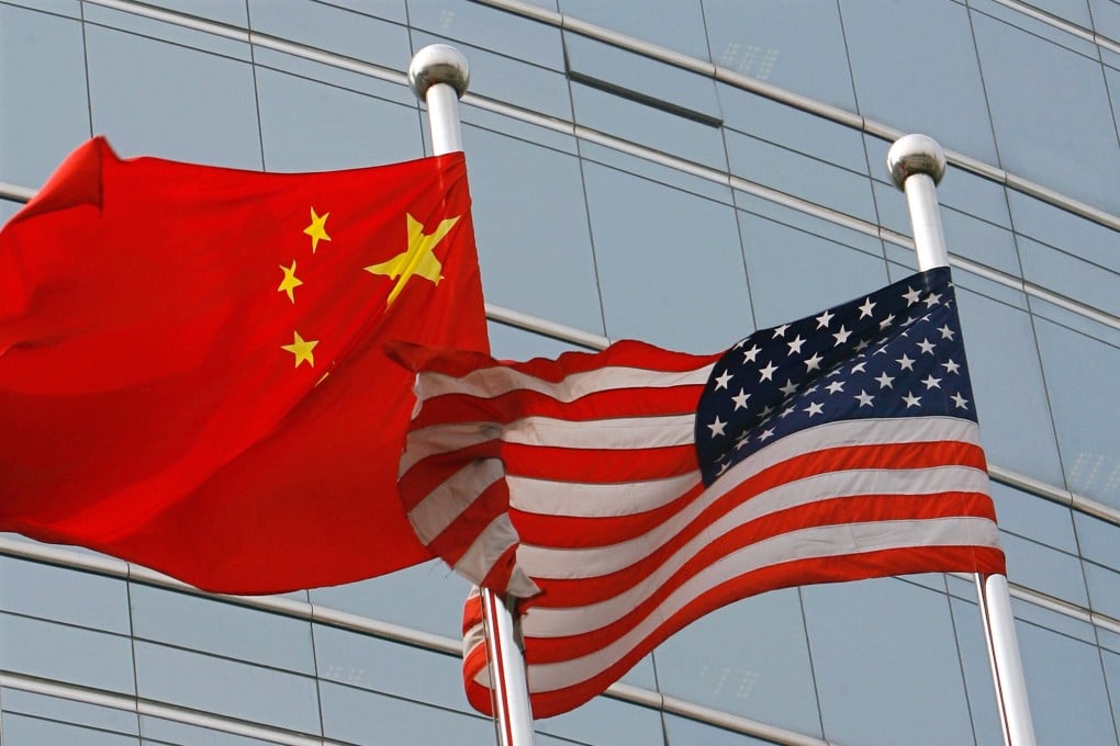 A US and Chinese flag wave outside a commercial building in Beijing. Photo: TNS