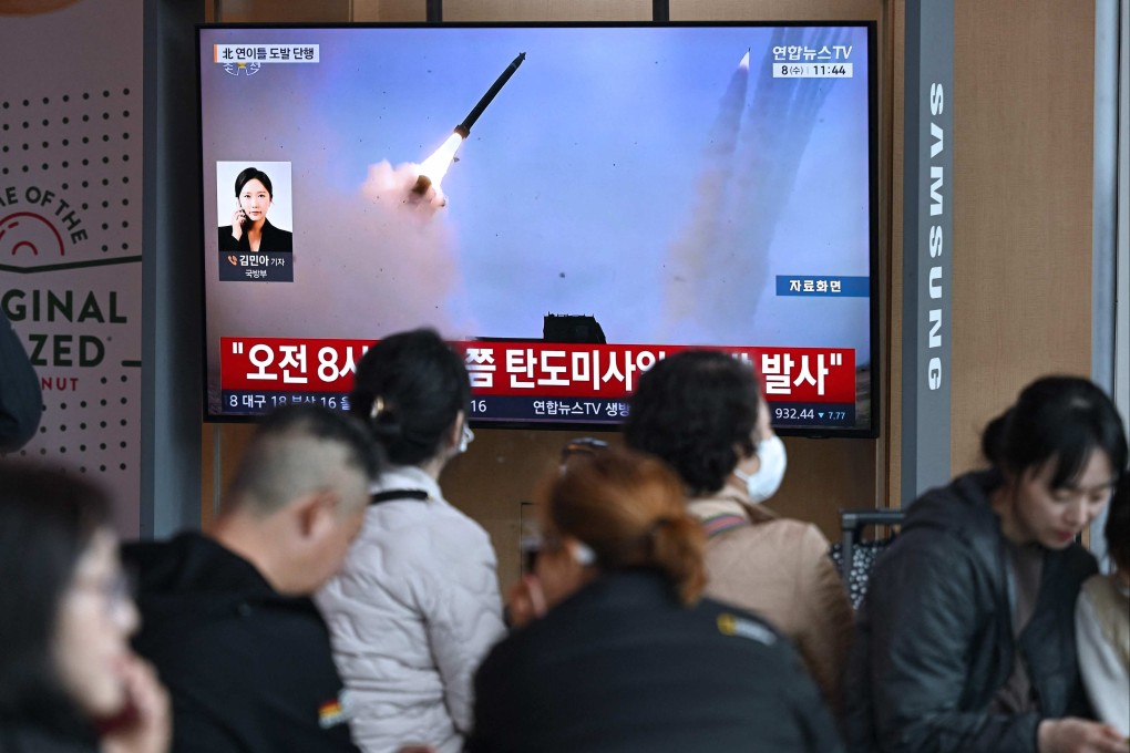People watch a television screen showing a news broadcast with file footage of a North Korean missile test, at a train station in Seoul in April. Photo: AFP