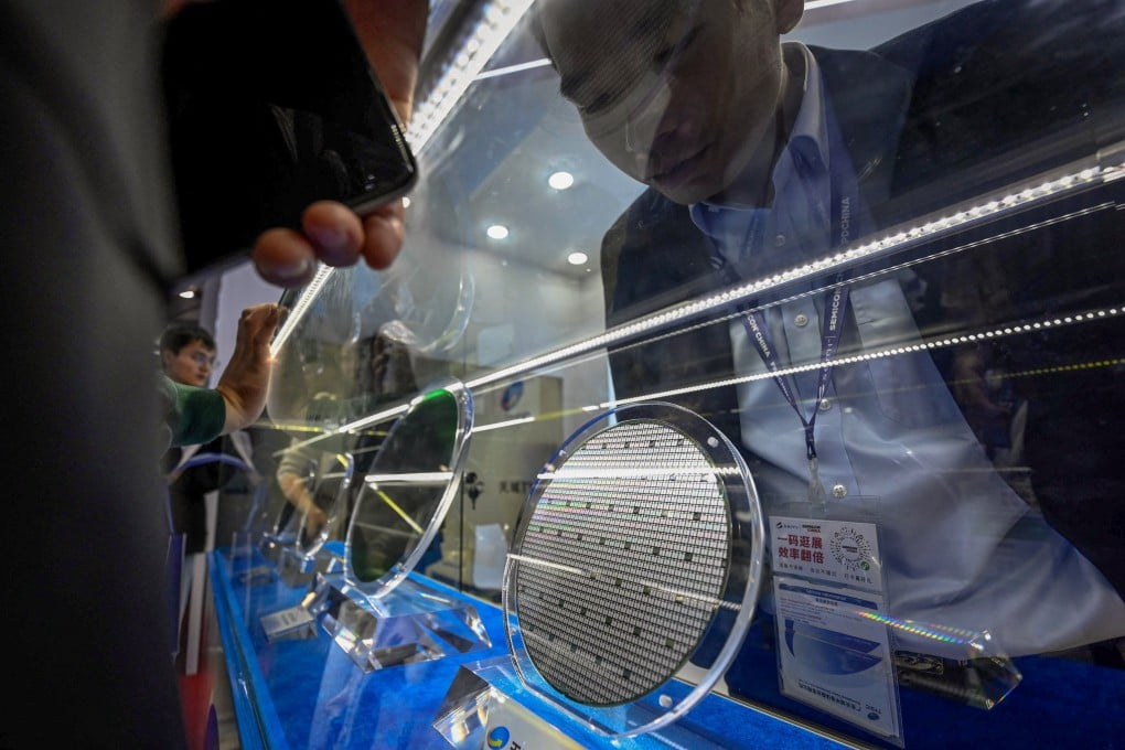 An exhibitor looks at a wafer during the Semicon China semiconductor exhibition in Shanghai on March 25. Photo: AFP