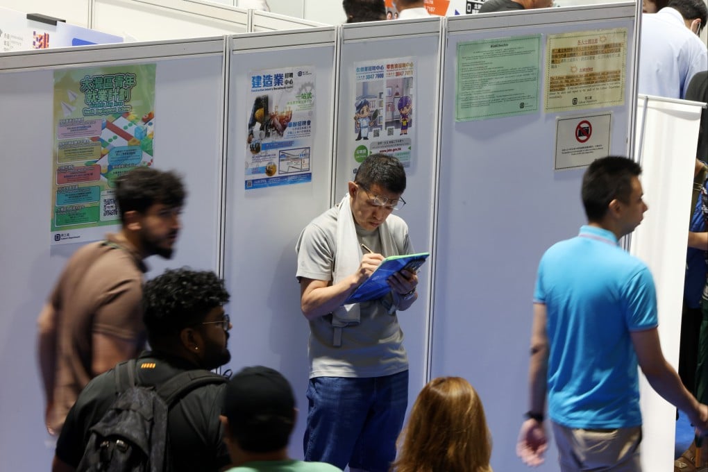 People walk past bilingual posters at the Building a Multicultural Workplace Job Fair held by the Labour Department at MacPherson Stadium in Mong Kok in 2025. Photo: Nora Tam