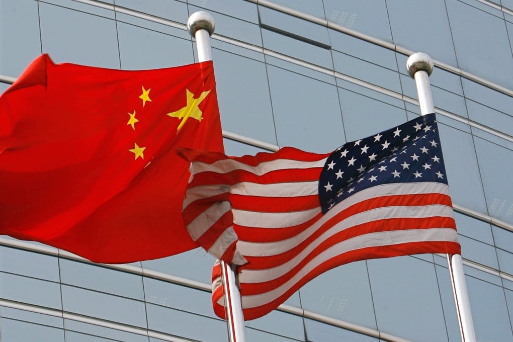 A US and Chinese flag wave outside a commercial building in Beijing. Photo: TNS
