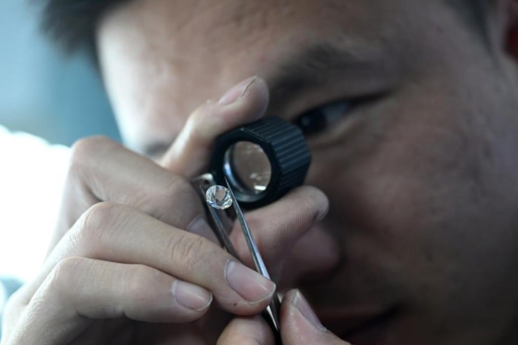A worker checks a diamond at a facility in China’s Henan province. Photo: Xinhua