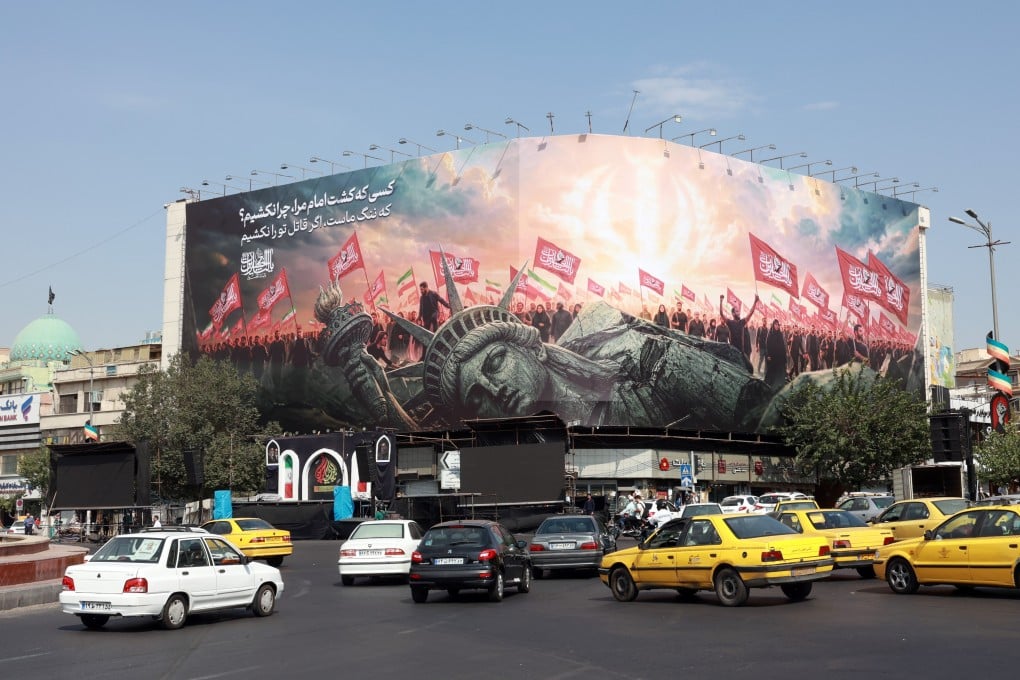 Vehicles drive past an anti-US billboard at Enghelab Square in central Tehran, Iran on Sunday. The Iranian Foreign Ministry said the agreement with Oman would not imply reopening the Strait of Hormuz without the United States accepting the Iranian proposals.  Photo: EPA