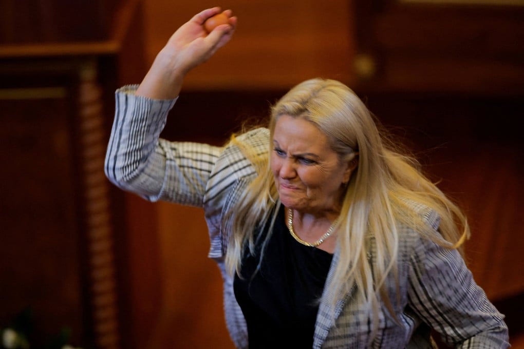 Opposition lawmaker Time Kadrijaj throws an egg at Prime Minister Albin Kurti (not pictured) during a plenary session to elect the new speaker of the parliament, in Pristina, Kosovo, on Saturday. Photo: Reuters