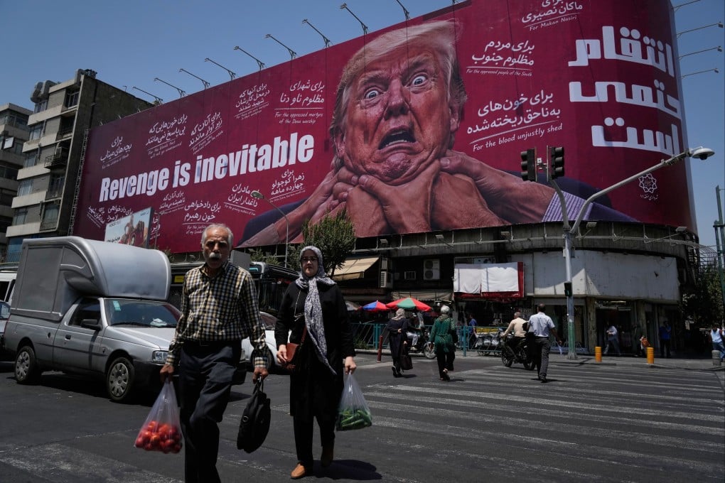 Pedestrians walk past a hoarding in Tehran in July depicting US President Donald Trump being grabbed by the neck alongside the message “Revenge is inevitable” in English and Farsi. Photo: AP