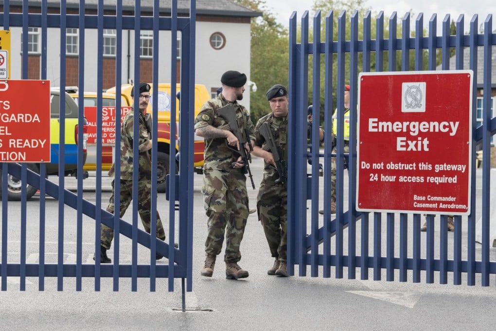 Armed military officers stand guard at Casement Aerodrome, where extradited alleged crime boss Daniel Kinahan landed in Ireland. Photo: EPA