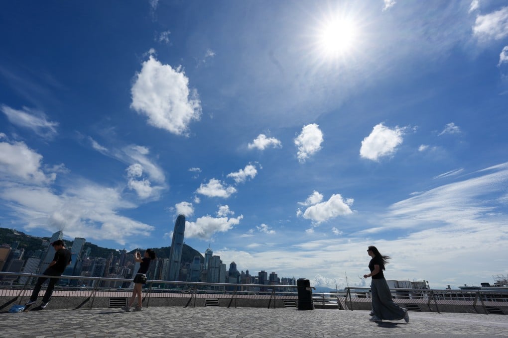 Pedestrians walk in view of the city skyline at Tsim Sha Tsui waterfront on June 30. As mainland China emerges as a superpower, Hong Kong must change with the rest of the nation, and for the better. Photo: Jelly Tse
