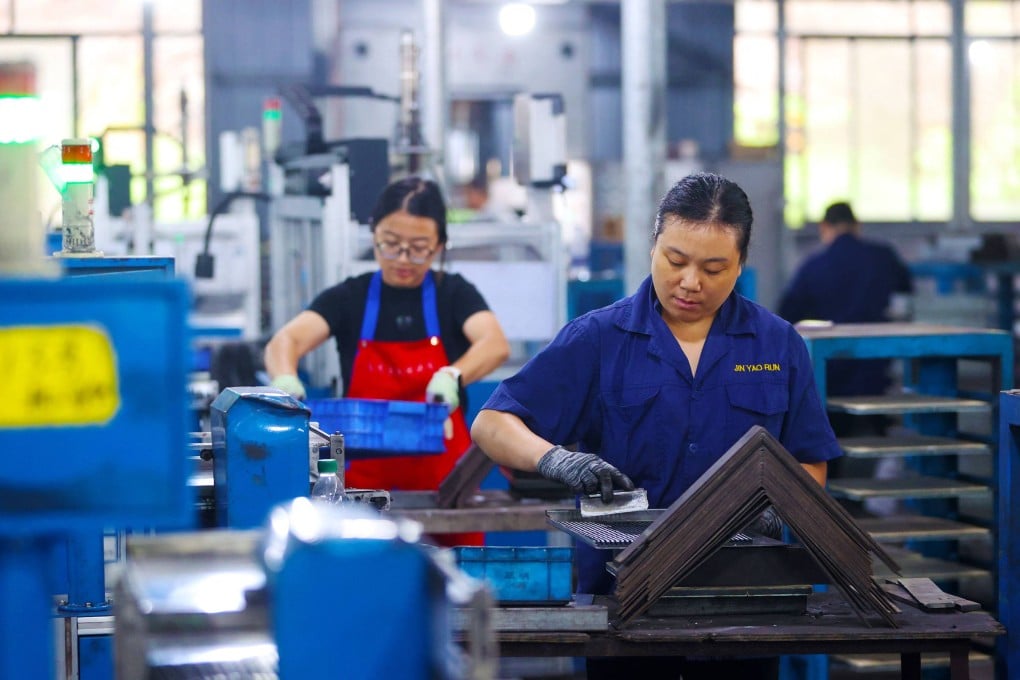 Employees work in an electronics factory in Chongqing on September 13. Photo: AFP