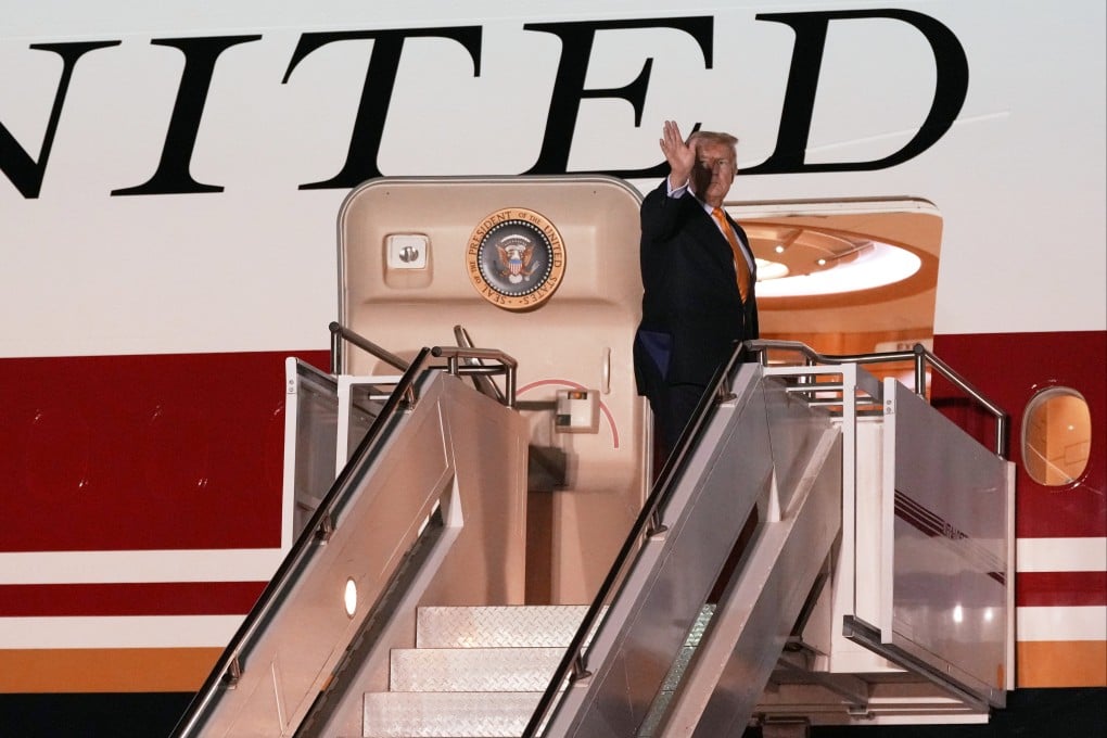 US President Donald Trump waves as he switches planes at an airbase in Suffolk, eastern England, on his way back to Washington from the Nato summit in Turkey last month. Photo: AP