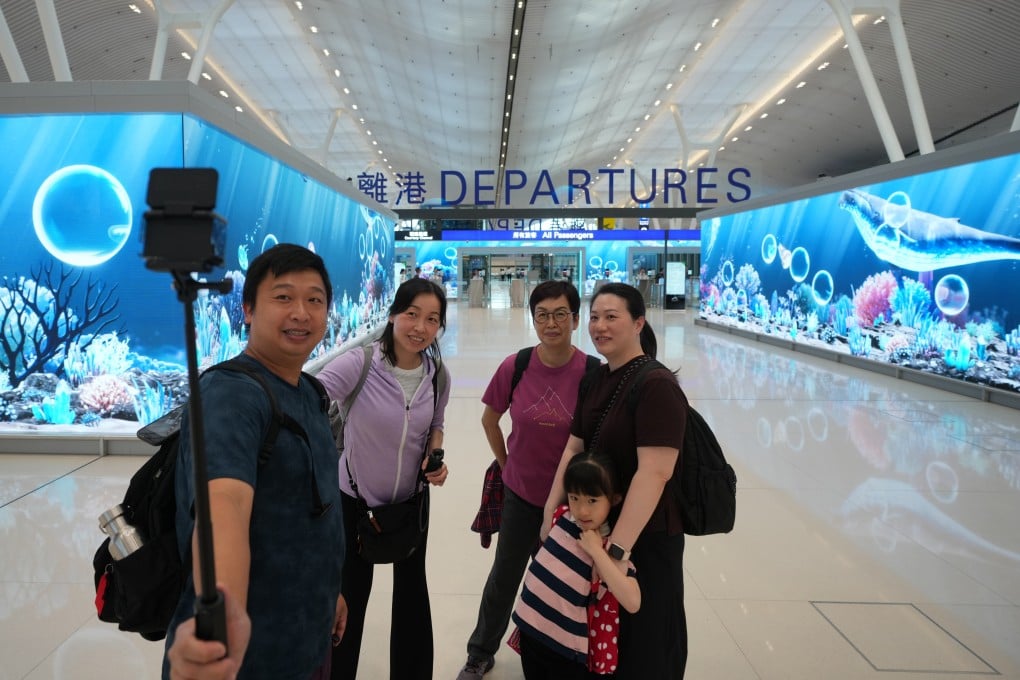 Passengers pose for pictures at Hong Kong International Airport in Chek Lap Kok on May 27. Photo: SCMP/Sam Tsang