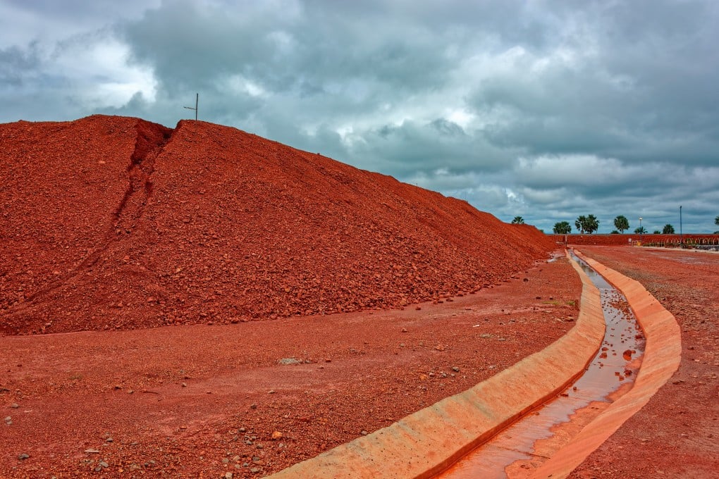 Large piles of bauxite ore, which is refined into aluminum, sit at a treatment area storage in Guinea. Photo: Shutterstock