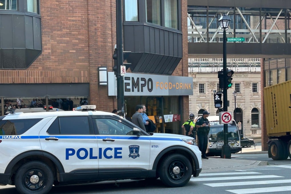 Police direct people asked to evacuate the US consulate in downtown Halifax, Canada on Monday. A suspect was charged with making a bomb threat on Tuesday. Photo: The Canadian Press via AP