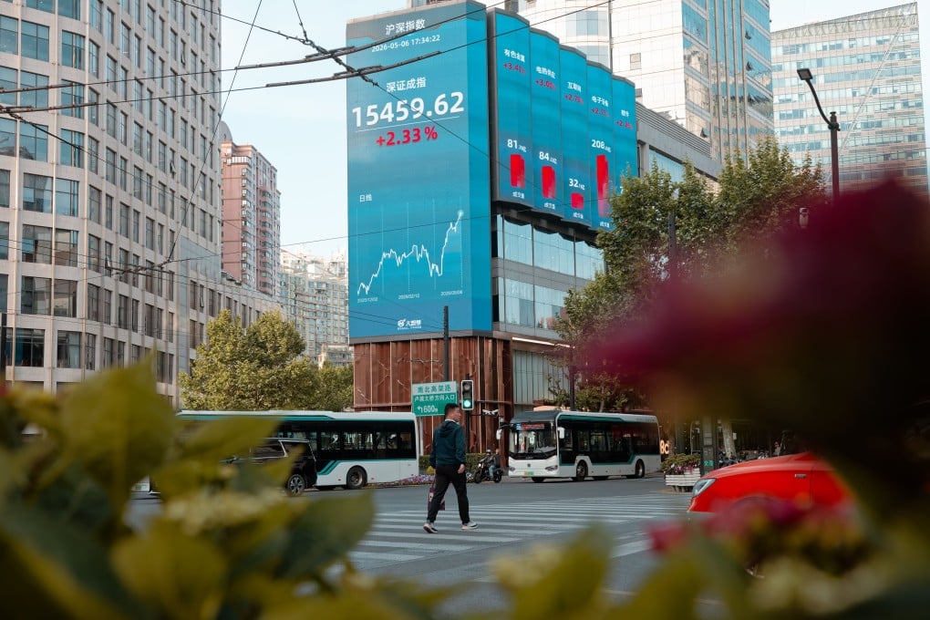 A large screen in Shanghai displays stock exchange and economic data in May. Photo: EPA
