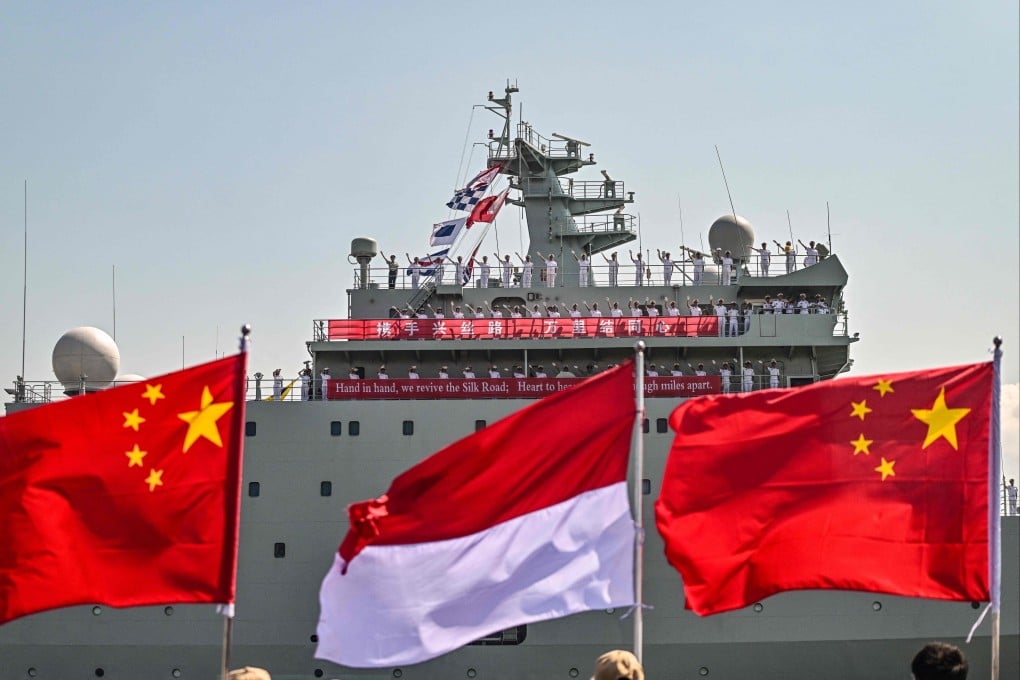 Crew members of the Chinese navy vessel Qi Jiguang wave as the ship prepares to dock at Tanjung Perak Port in Surabaya, Indonesia, on August 2. Photo: AFP