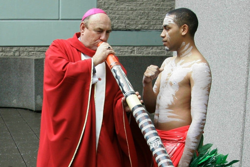 Bishop Christopher Saunders of Broome tries to play a didgeridoo in Sydney, Australia in 2008. Prosecutors alleged Saunders lured young Indigenous men to his church-owned house with free alcohol and cigarettes paid for with church funds. Photo: AP