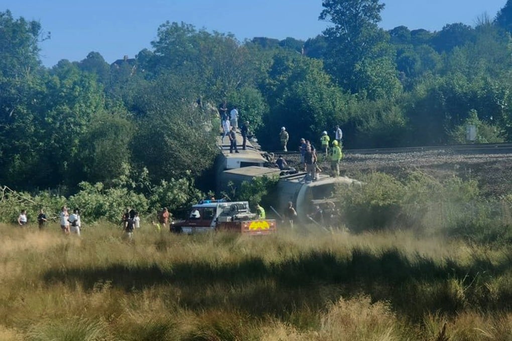 Emergency services workers are seen on the carriage of a derailed train near the town of Lewes, southern England, on Wednesday. Photo: X/ladyrose1983 via AFP