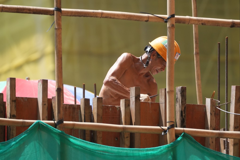 A construction worker works during extremely hot weather in To Kwa Wan on August 10. To keep outdoor workers safe and productive, measures like phased work schedules and portable cooling stations could help. Photo: Sam Tsang