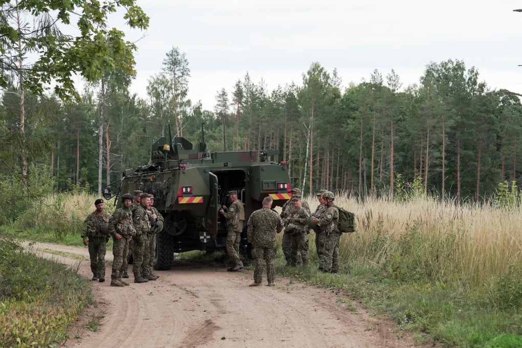 Servicemen of the Latvian National Guard gather before a search operation for the debris from an intercepted drone, in Rugaji, Latvia, on Friday. Photo: Reuters